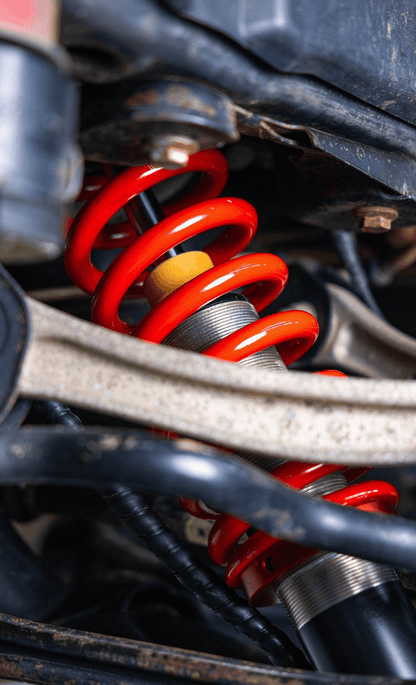 Porsche Cayenne 955/957 & VW Touareg Gen 1/1.5 Nitrogen Coilovers – 9-Step Adjustable (2002–2010) - OverlandtrekLift Suspension SystemOverlandtrekOT-UNI-LK-COILPorsche Cayenne 955 (2002–2007)Coilover installed on a Porsche Cayenne — under-car view of the spring and bump stop